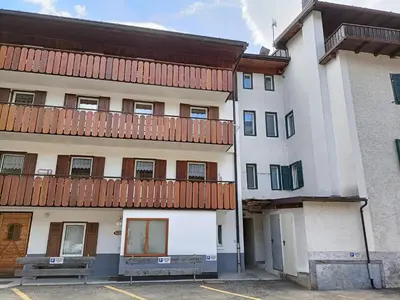 an apartment building with a balcony on top of it at Casa Paola in Pozza di Fassa