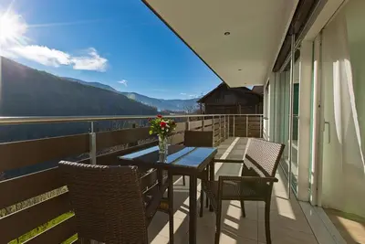 a table and chairs on a balcony with a view at Villa Ried in Perca