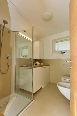 a bathroom with a shower and a sink and a toilet at Villa Ried in Perca