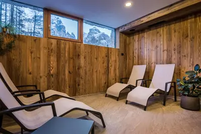 a group of chairs in a room with wooden walls at Garni Larix in Colfosco