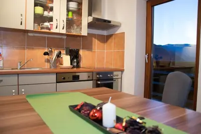 a kitchen with a table with a plate of food on it at Partschillerhof in Fiè