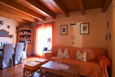 a living room with a couch and a table at Isarco Suite in Vipiteno