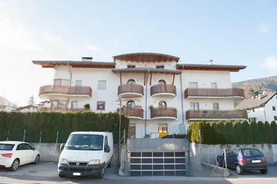 a white van parked in front of a building at Isarco Suite in Vipiteno