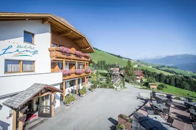 arial view of a building on a mountain at Almhotel Lenz in Valdaora