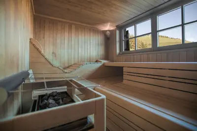 a sauna with stairs and a window in it at Almhotel Lenz in Valdaora