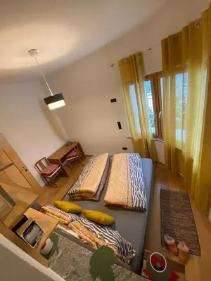 a small room with a bed and a table at Villa Alessandra in Colle Isarco