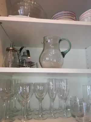 a bunch of wine glasses sitting on a shelf at Villa Alessandra in Colle Isarco