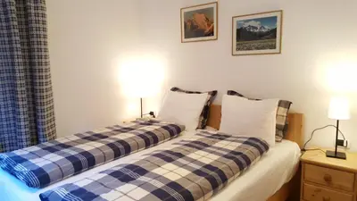 two beds sitting next to each other in a bedroom at Casa Alfredino in Rocca Pietore