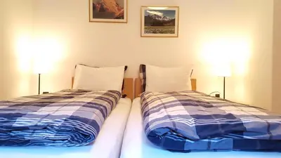 two beds sitting next to each other in a room at Casa Alfredino in Rocca Pietore