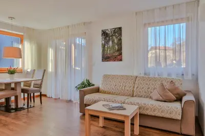 a living room with a couch and a table at Prünsterhof Schenna in Schenna