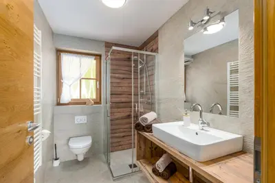 a bedroom with a bed with white sheets and red pillows at Tratterhof Apartments in Vallarga