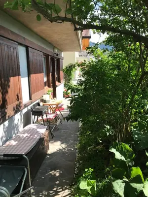 a porch of a house with a bench and a table at Almida in Castello di Fiemme