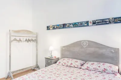 a bedroom with a bed with two pillows on it at Bolzano Rooms in Bolzano