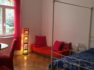 a bedroom with a canopy bed and red pillows at Bolzano Rooms in Bolzano