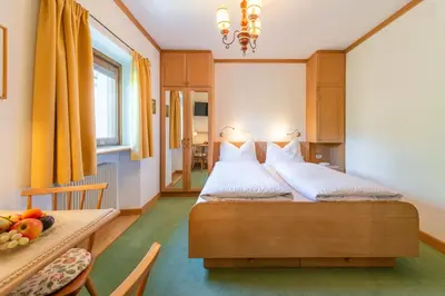 a bedroom with two beds and a table with fruit at Haus Oberhofer in Cornaiano
