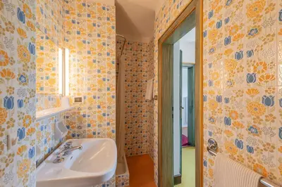 a bathroom with a sink and a mirror at Haus Oberhofer in Cornaiano