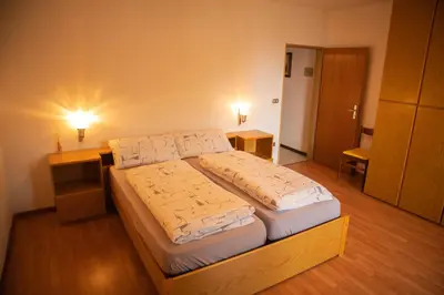 a dining room with a table and chairs in a room at Apartments Max in Mendola