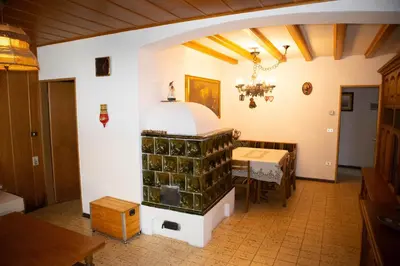 a room with a table and a stove in it at Apartments Max in Mendola