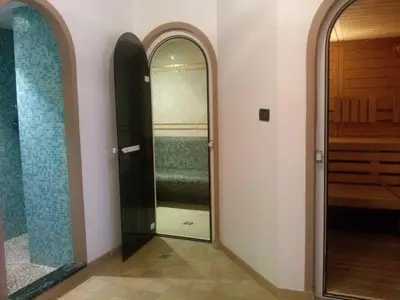 a hallway with two mirrors and a walk in closet at Albergo Arnica in Canazei