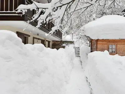 a pile of snow in front of a house at Studio Apt 14 by Interhome in Alba di Canazei