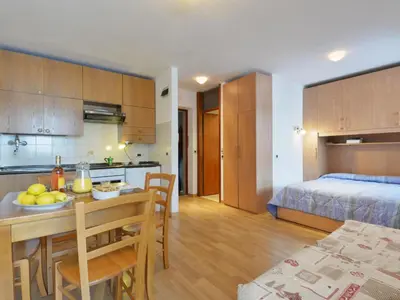 a kitchen and a room with a table and a bed at Studio Apt 14 by Interhome in Alba di Canazei
