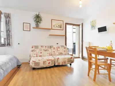 a bedroom with a bed and a couch and a desk at Studio Apt 14 by Interhome in Alba di Canazei