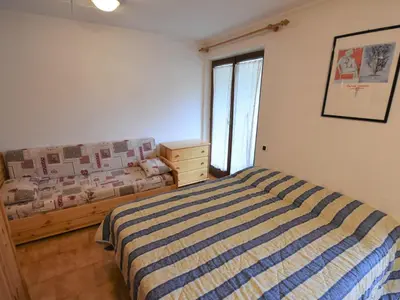 a bedroom with a bed and a window in it at Studio Apt 8 by Interhome in Alba di Canazei