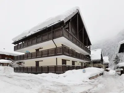 a large building with snow on the roof at Studio Apt 8 by Interhome in Alba di Canazei