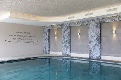 a swimming pool in a hotel room with at Hotel Mitlechnerhof in Schenna