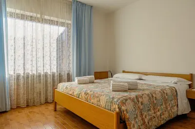 a bedroom with a bed with towels on it at Cèsa Silvano in Rocca Pietore