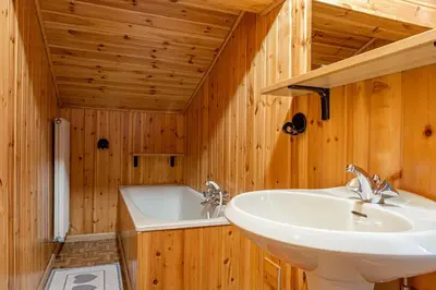 a bathroom with a tub and a toilet and a sink at Cèsa Silvano in Rocca Pietore