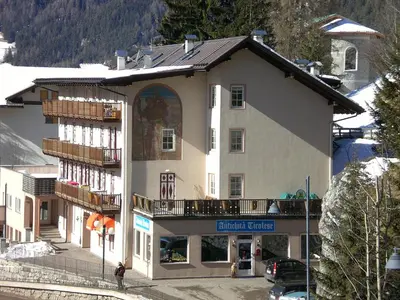 a large white building with a sign on it at San Cristoforo in Canazei