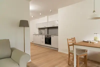 a kitchen and dining room with a table and a couch at Huberhof Meran in Merano