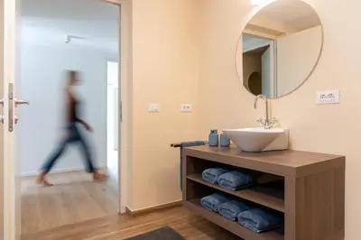 a bathroom with a sink and a mirror at Huberhof Meran in Merano