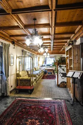 a room with beds and a rug on a floor at Hotel Relais Grünwald in Cavalese