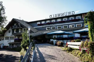 a building with a sign on the front of it at Hotel Relais Grünwald in Cavalese