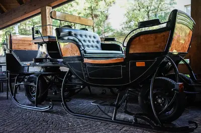 a horse drawn carriage parked in a building at Hotel Relais Grünwald in Cavalese