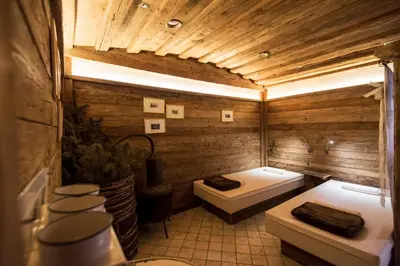 a bathroom with a tub and a toilet in it at Charmehotel Uhrerhof - Deur in Ortisei