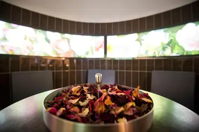 a bowl of salad on a table in a restaurant at Charmehotel Uhrerhof - Deur in Ortisei