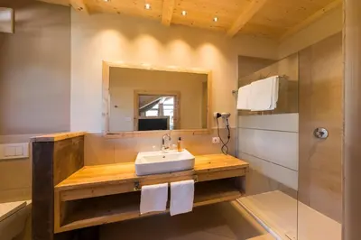 a bathroom with a sink and a mirror at Naturhotel Sonnenhof in Chiusa