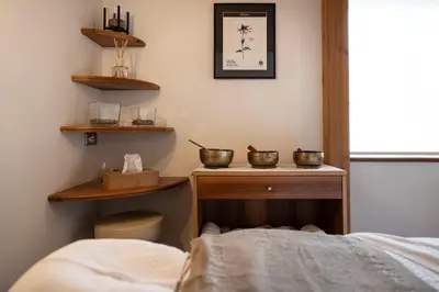 a room with a bed and two bowls on a table at Artnatur Dolomites Hotel & Spa in Siusi