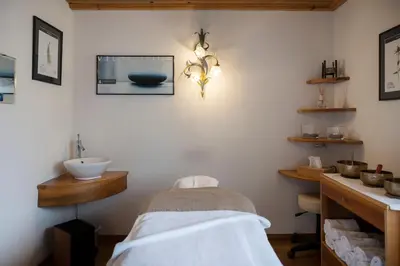 a bathroom with a sink and a counter with a sink at Artnatur Dolomites Hotel & Spa in Siusi