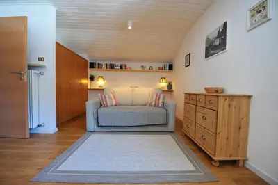 a living room with a couch and a table at Apartments Villa Rosa in Selva di Val Gardena