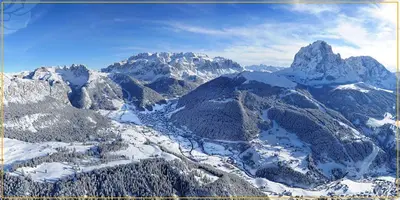 a building with a mountain in the background at Apartments Villa Rosa in Selva di Val Gardena