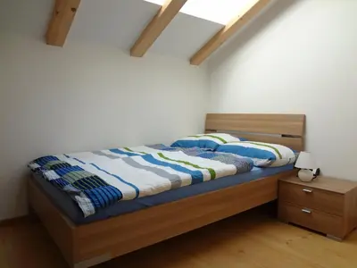 a bedroom with a bed with a blue comforter at Ritzhof in Funes