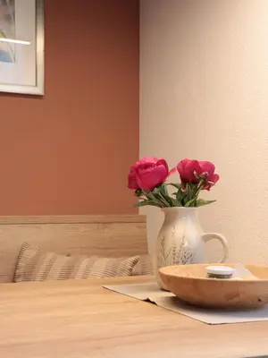 a vase with pink roses in it on a table at Liebharterhof in Valdaora