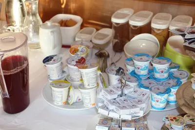 a table with a bunch of containers of food at Pension Schönblick in Campo di Trens