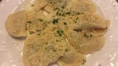 a plate of food with ravioli on a table at Pension Schönblick in Campo di Trens