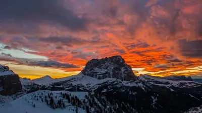 a sunset over a snow covered mountain at Hotel Garni Ruscel in Santa Cristina in Val Gardena