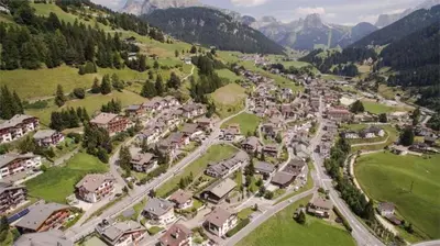 an aerial view of a village in the mountains at Hotel Garni Ruscel in Santa Cristina in Val Gardena